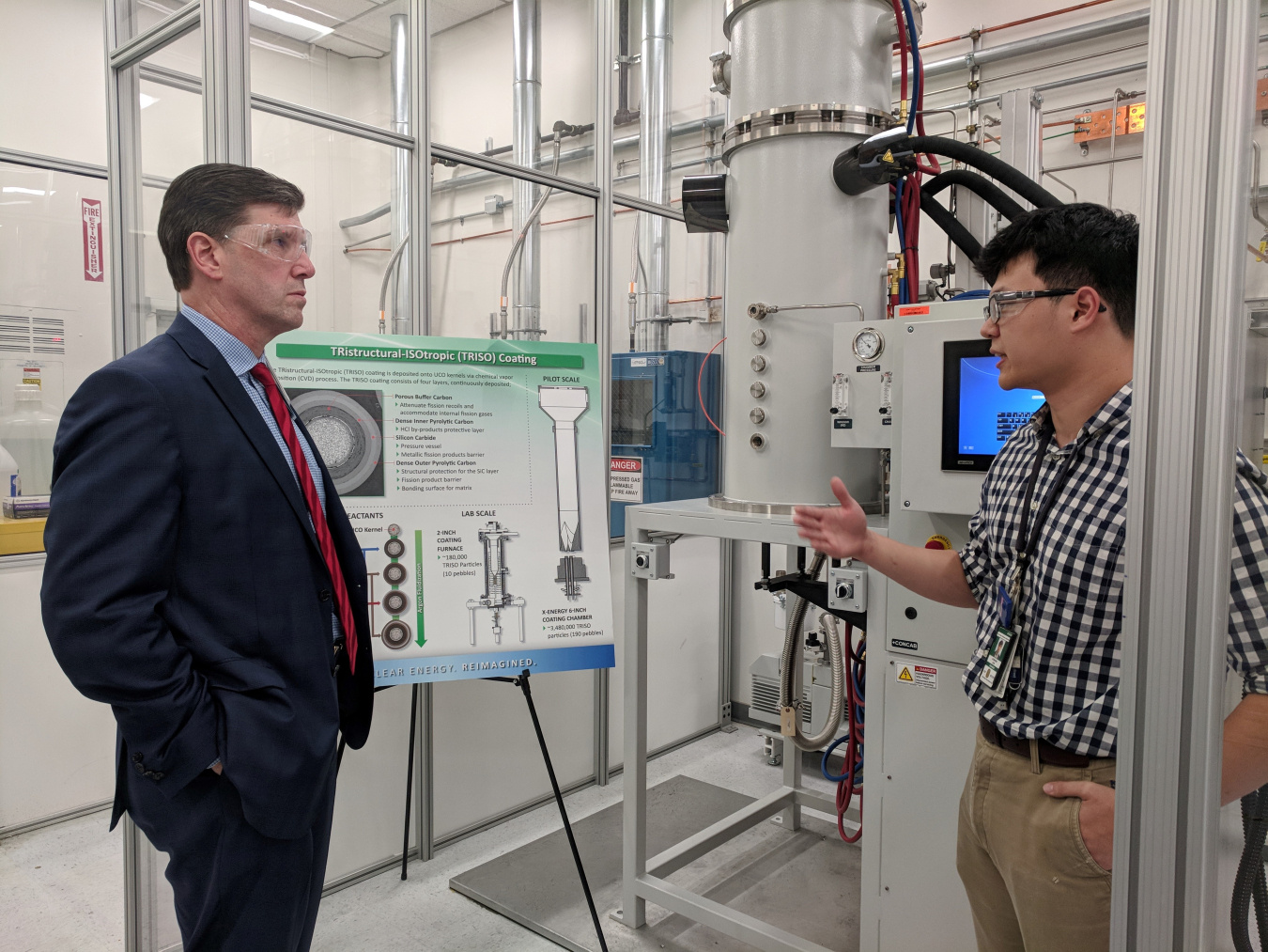 Two men look at equipment at Oak Ridge National Laboratory