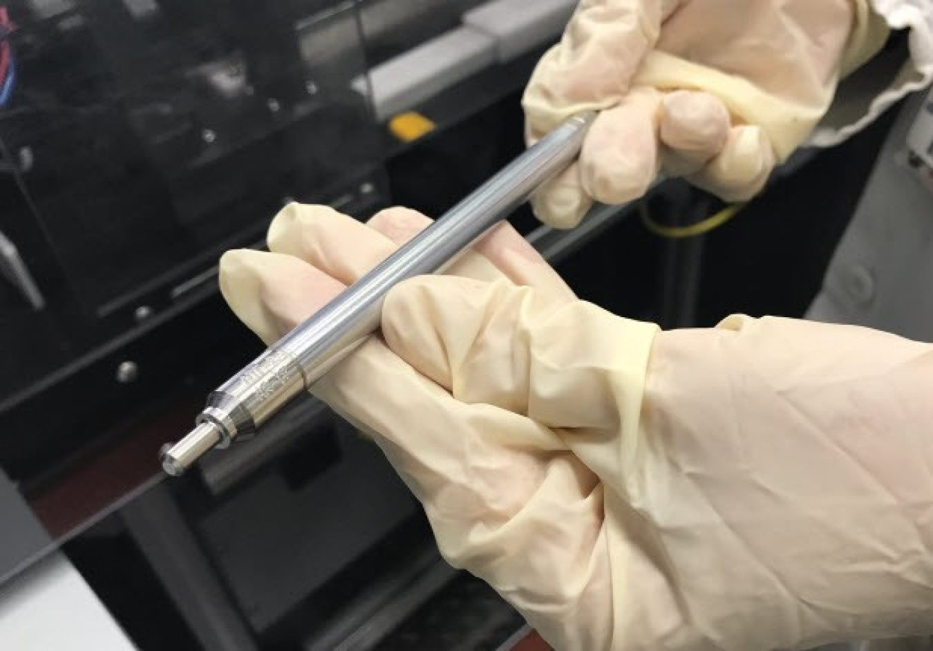 Picture of hands holding a test fuel pin designed by Framatome.