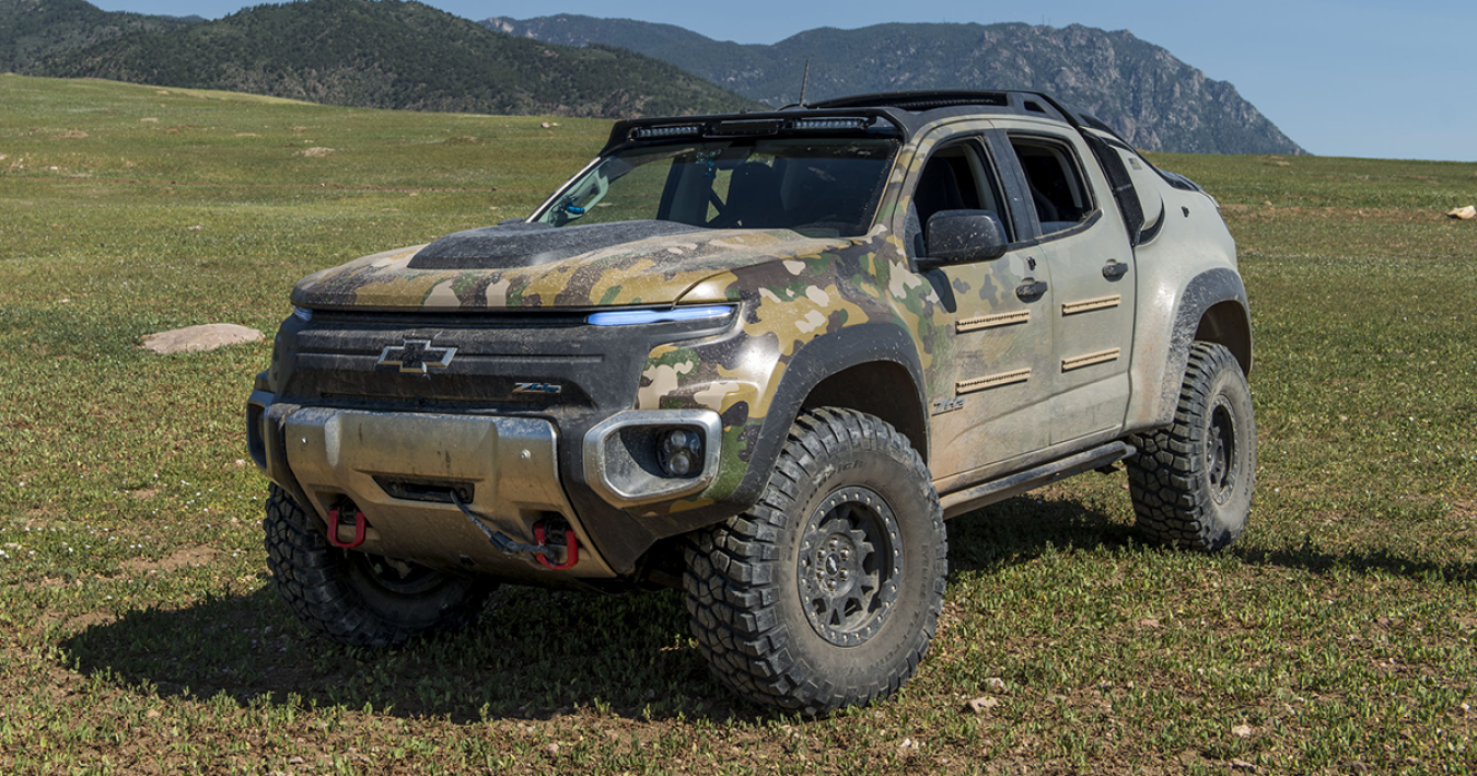 A Chevy truck that is powered by a battery and fuel cells with mountains in the back drop.