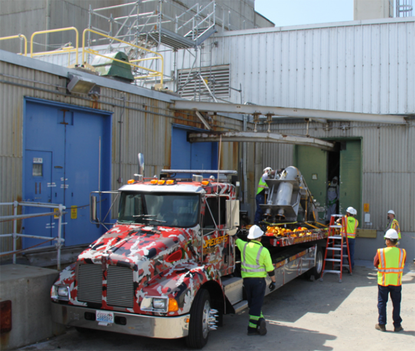 Photo 2 Workers delivering sludge removal equipment_700 pixels.jpg