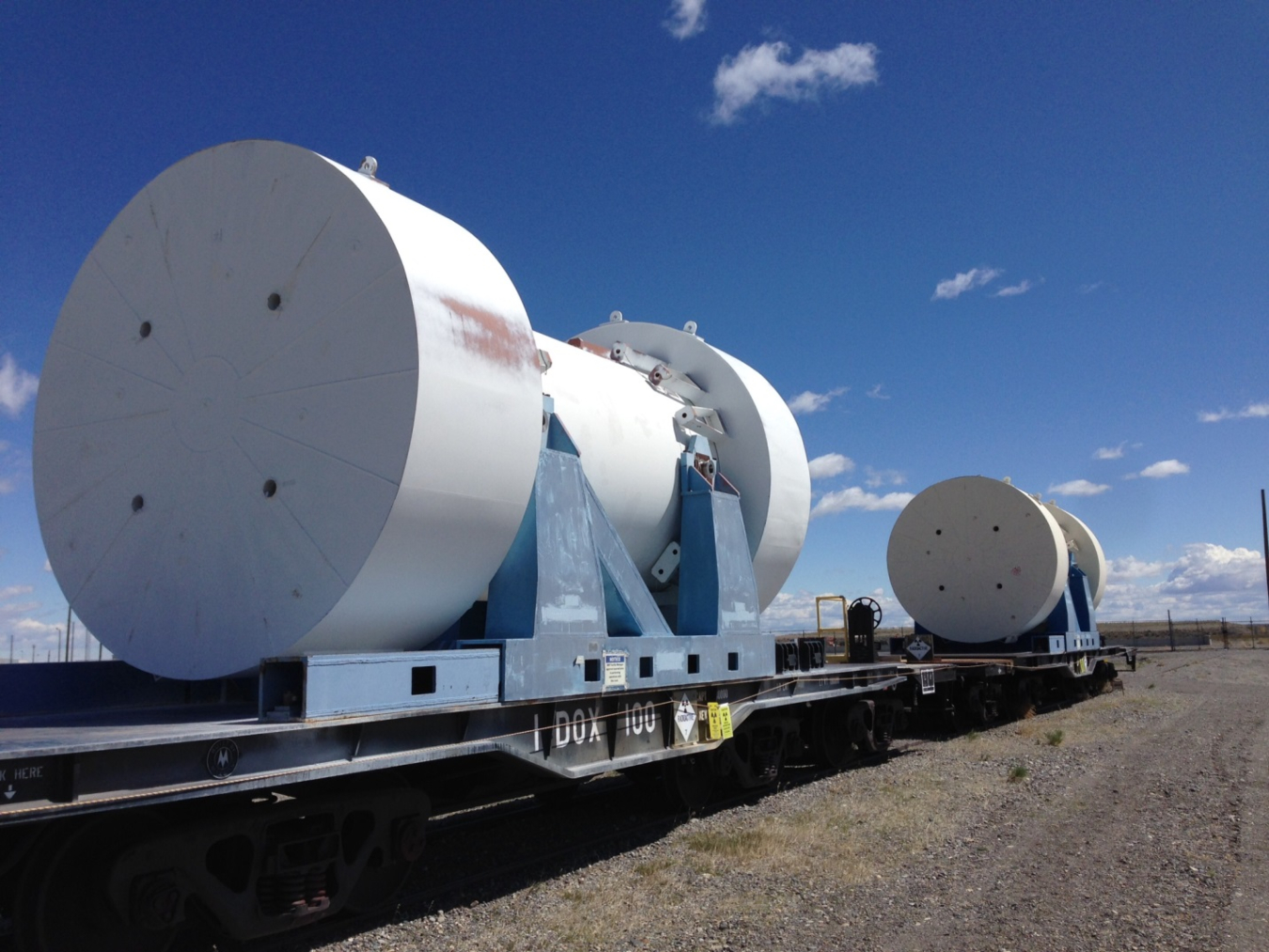 Photo of a transportation cask against a bright clear sky.
