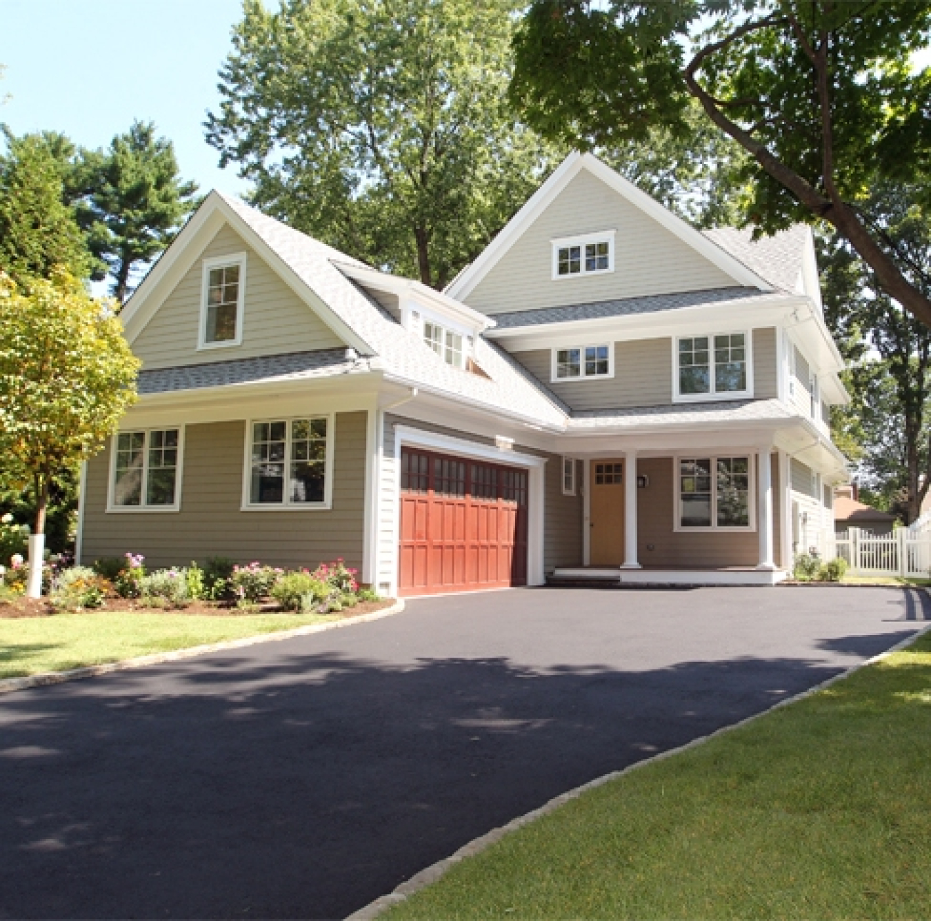 This photo shows a two-story home at the end of a driveway with garage in front.