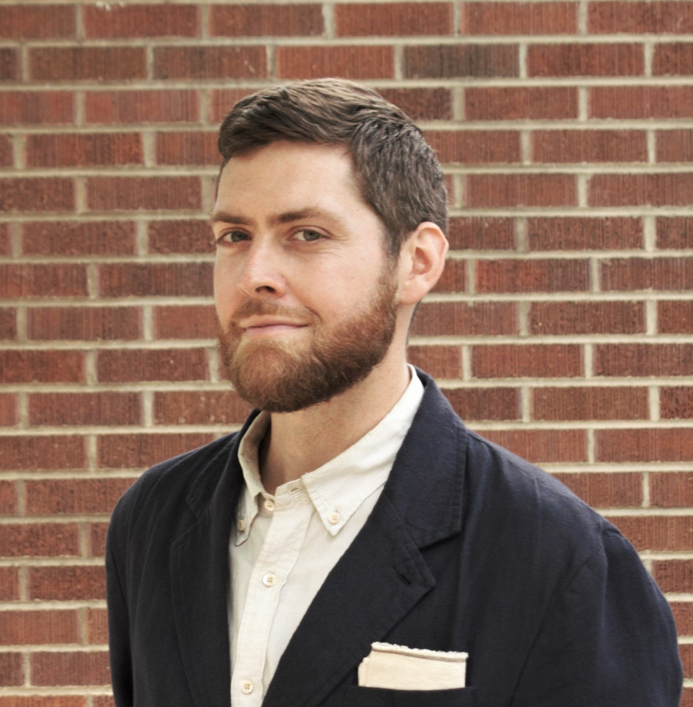 Head-and-shoulders photo of Merrill Wyatt in front of a brick wall.