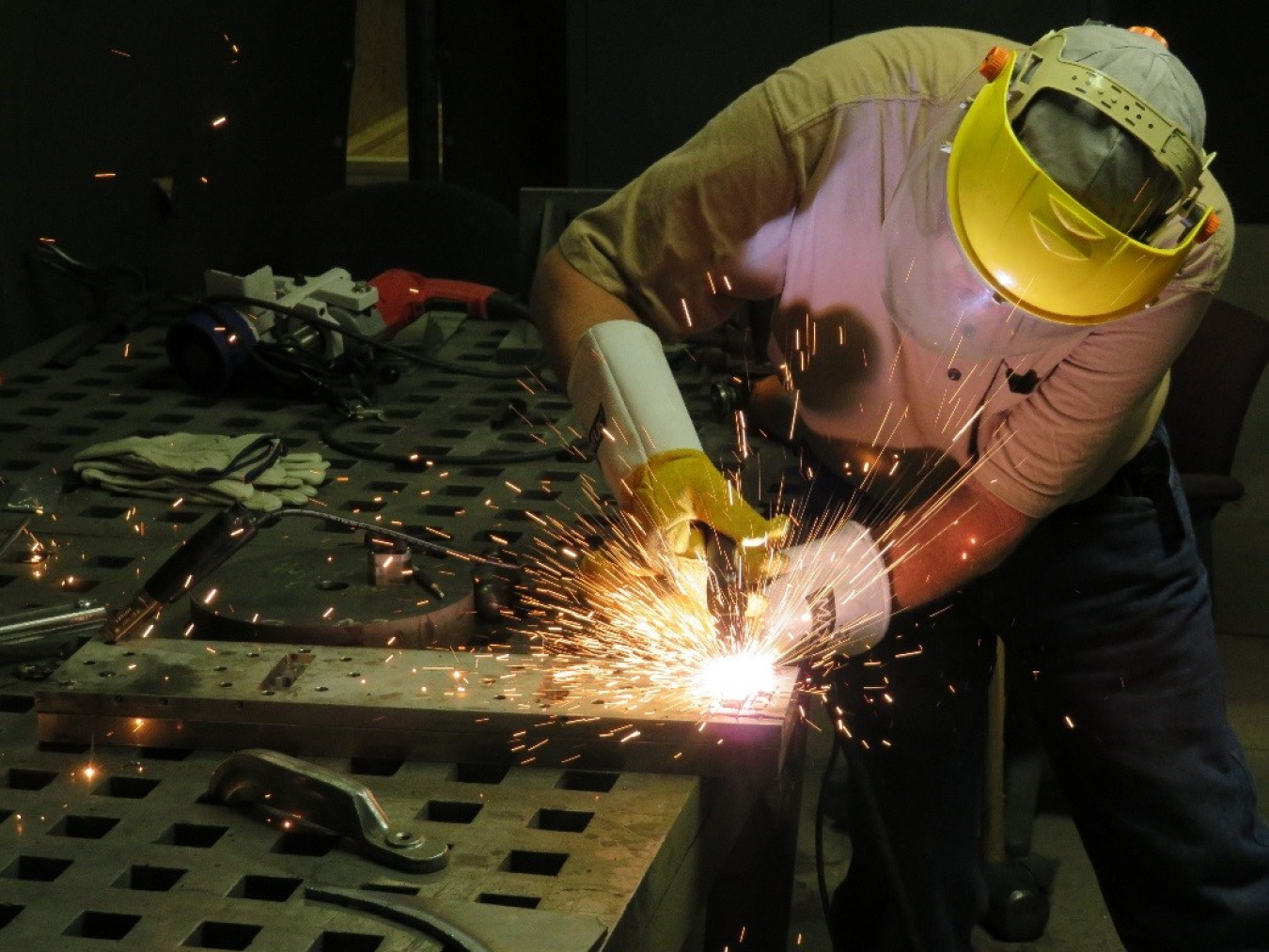 A Sandia National Laboratories engineer tests how difficult it is to cut through material used as part of an IDD kit design.