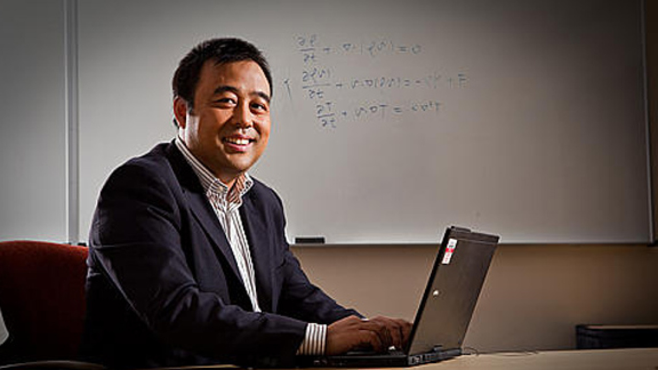An photo of a scientist on a laptop.