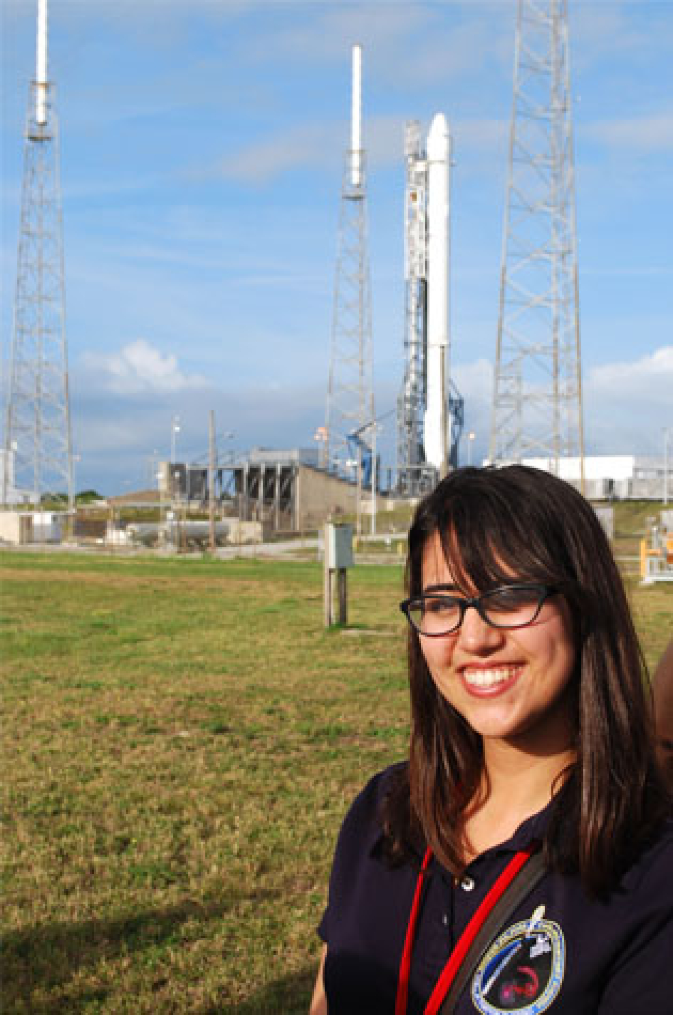 Emily Martinez stands in front of the Falcon 9 rocket before her experiment launches to the International Space Station.