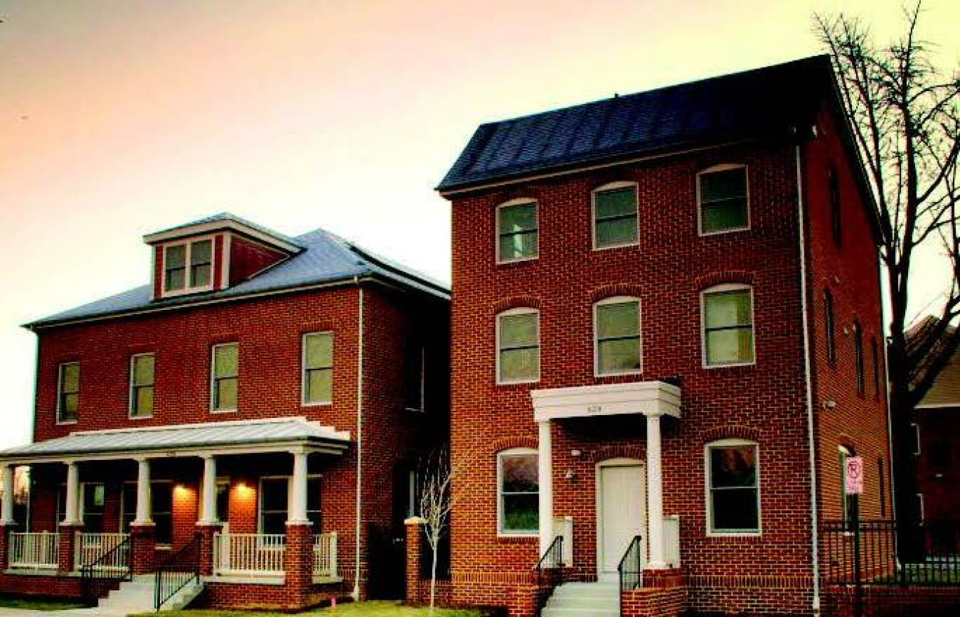 This photo shows two brick homes that have been upgraded into high-performance homes.