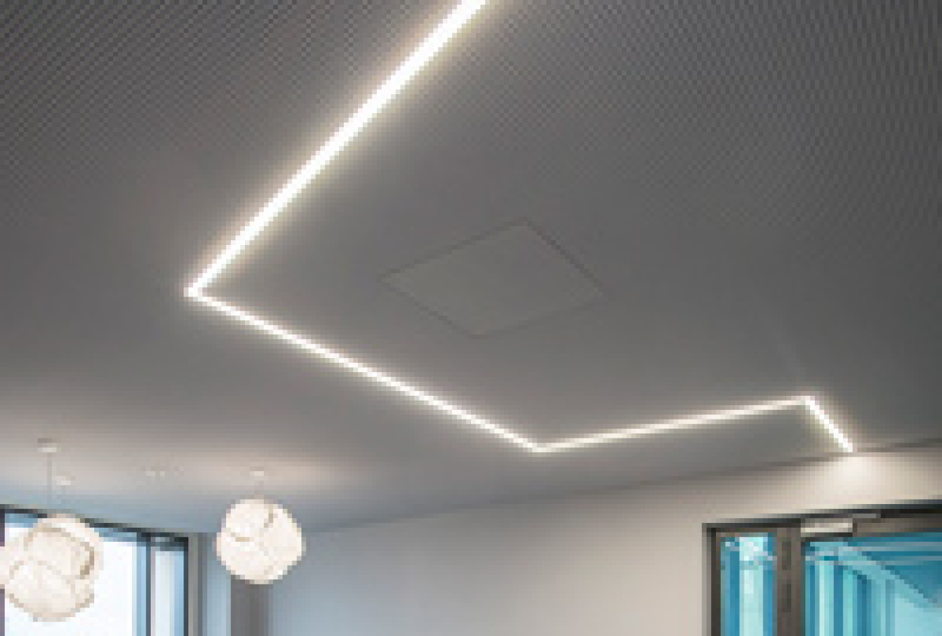 Photo of color-tunable LED luminaires on a ceiling.