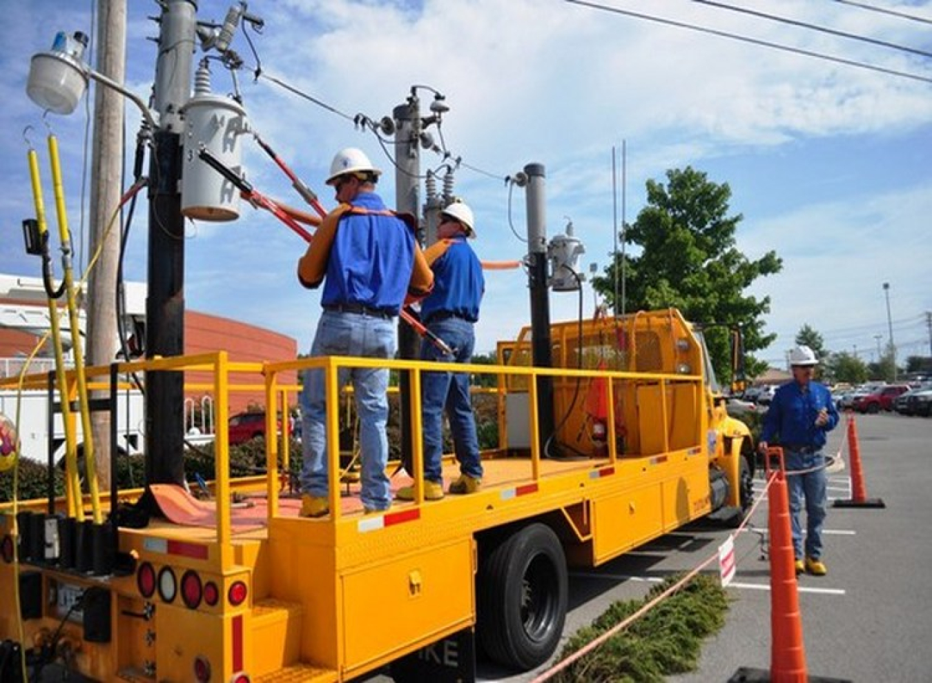 Electrical workers, repairing utility pole and line.