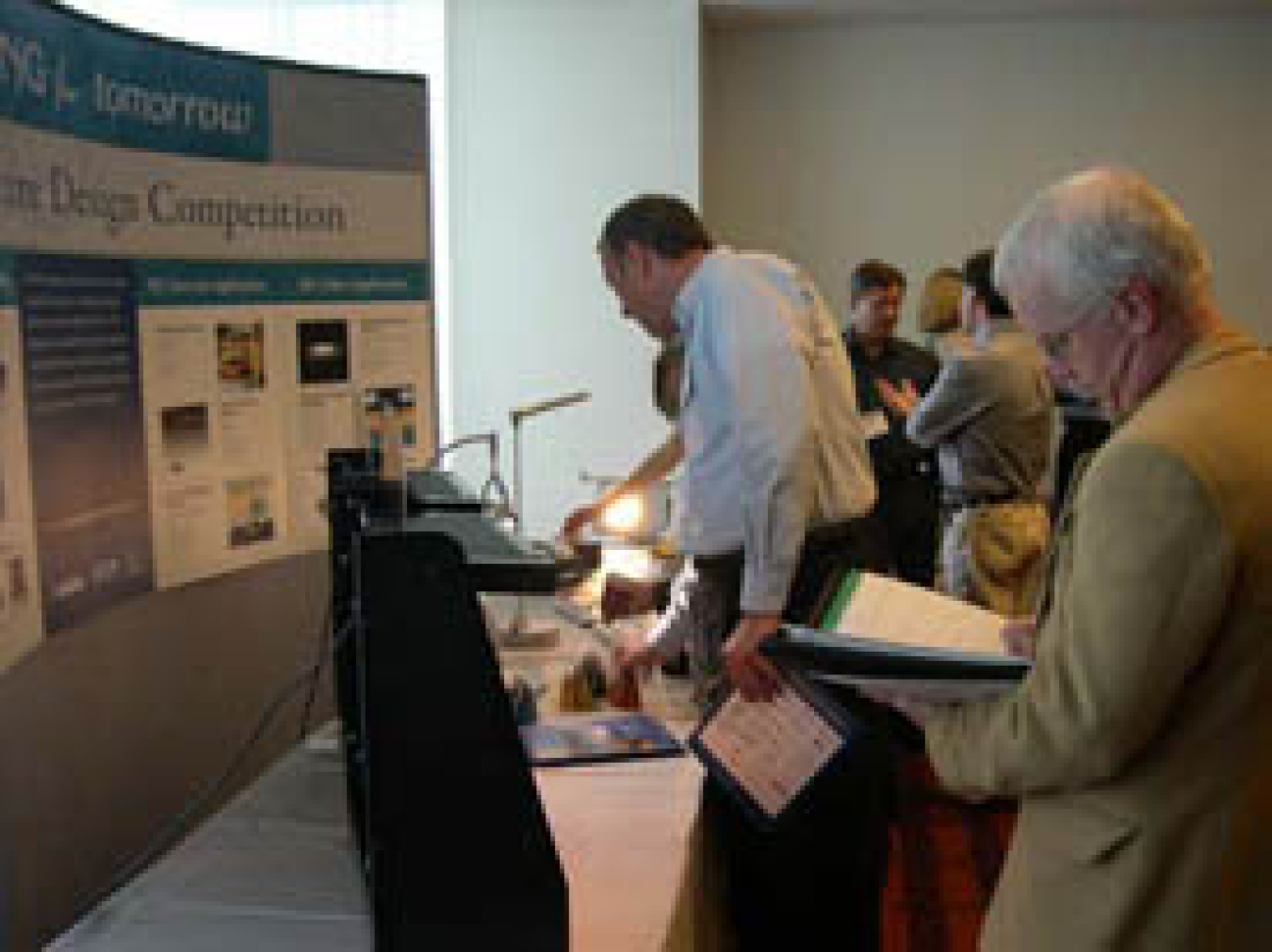 People gathered around a display booth.