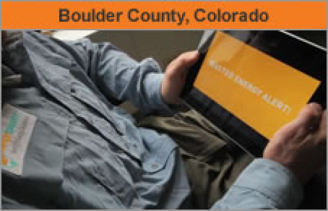 Torso of a man holding a computer tablet with the words "Boulder County, Colorado."