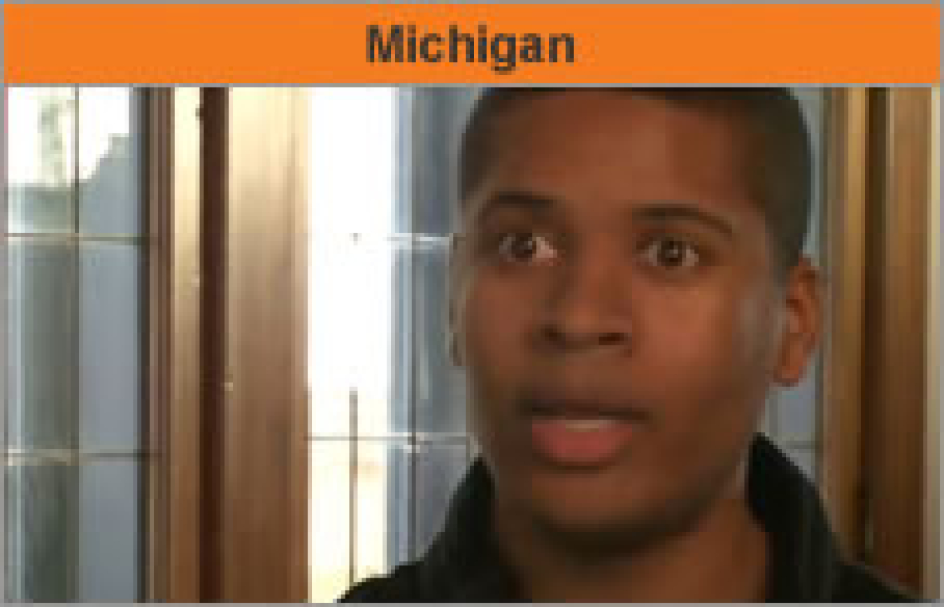 Head and shoulders of a man turned toward the camera, with the word "Michigan."