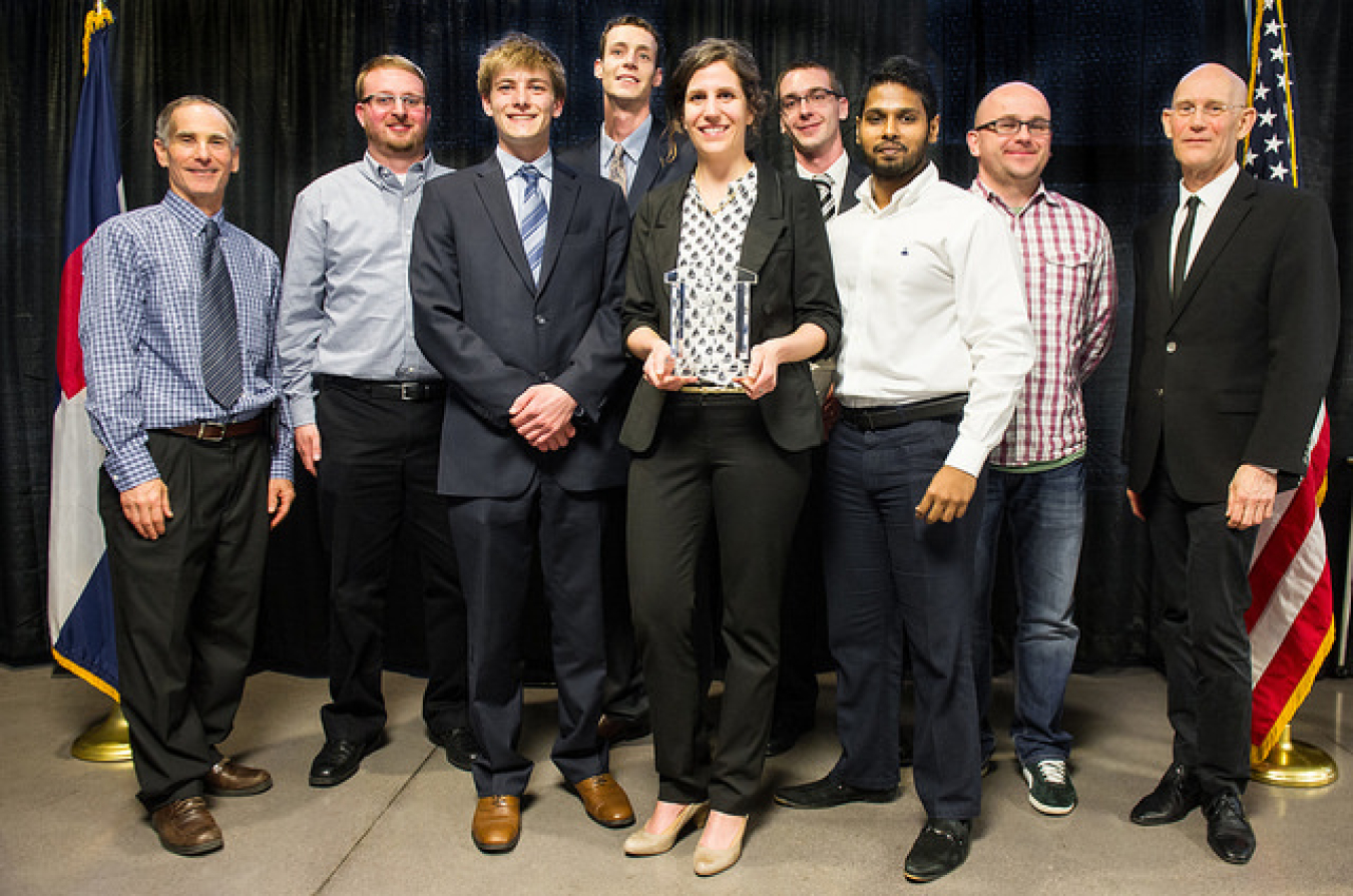 This photo shows one of the Grand Winner teams at the 2014 Student Design Competition, holding their trophy.