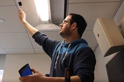 photo of a man looking at a light fixture