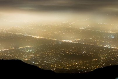 view of a city from the top of a mountain at night.