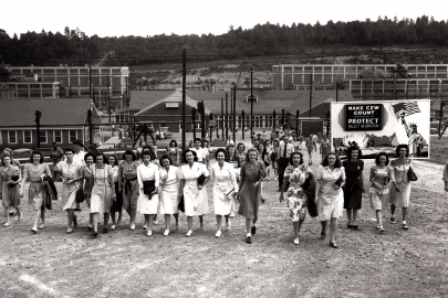 Photograph depicts a large grou of women workers after a shift change at the Y-12 plant in Oak Ridge.