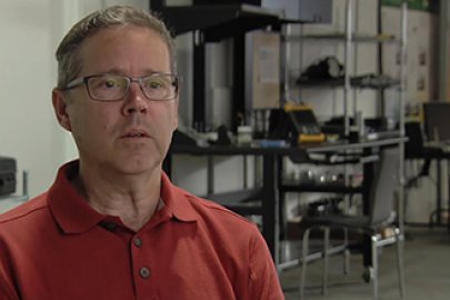 Photo of a man in a red shirt.