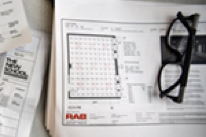 photo of a person working on blueprints.