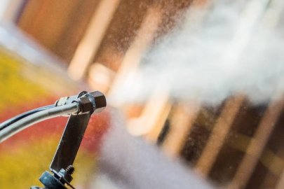 Photo of a hose spraying on a home.
