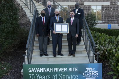 Elected officials gathered with Site leaders on the steps of the Aiken Municipal Building on Nov. 16 to bestow the framed resolution to the SRS.