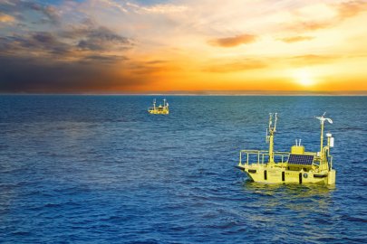 Photo of two buoys in the water with a graphic overlay to indicate data flowing into the buoy and number of registered users (1,060) and registered projects (20).