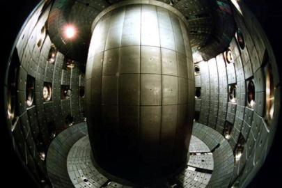 Tokamaks, such as the Tokamak à Configuration Variable (TCV) shown here, are donut-shaped devices that confine plasma to produce fusion reactions. The shape of the plasma cross-section affects the quality of the containment. 