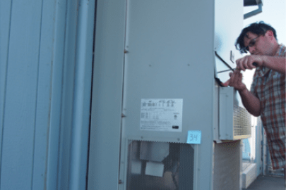 A man working on an HVAC unit.