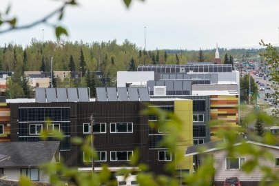 A photo of several buildings in an urban area with solar panels on the roofs