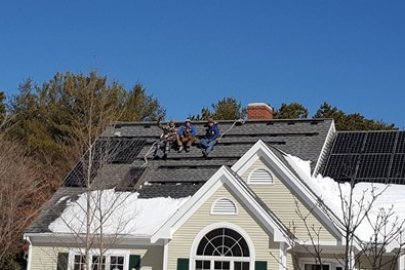 Solar workers on top of a residential home.