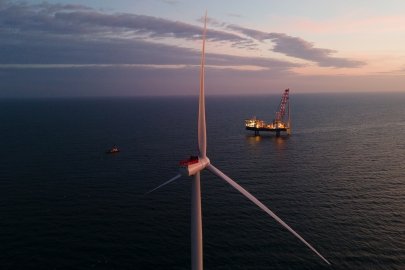 Offshore wind turbines and a boat at sea.