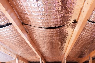 The foil-faced insulation behind this fireplace provides an air barrier and  thermal shield.