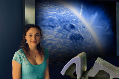 Livia Casali of General Atomics stands with the Small Angle Slot (SAS) divertor model. Casali and her team combined the SAS configuration with impurity injection to improve integration between the hot core of a plasma and the cooler edge.