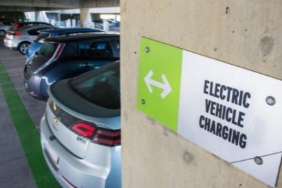 Photo of electric vehiclc charging station sign in parking garage