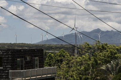 Wind turbines in a city and mountains. 