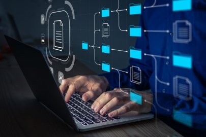 Person working on a laptop, with an illustration of a folder structure HUD overlayed on the image.