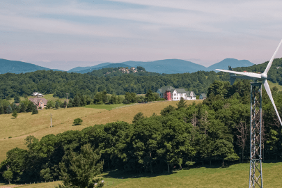 Distributed wind turbine with mountains in the background.