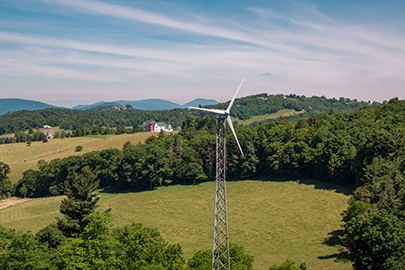 Distributed wind turbine with mountains in the background.