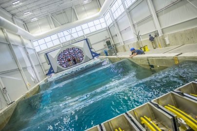 Machinery create waves in a tank used to test marine energy devices.