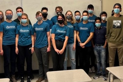 Students in masks wearing matching tee shirts with the words “Wind Power Cal Poly.”