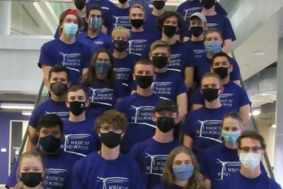 Students wearing face masks and matching “Wildcat Wind Power” t-shirts standing on a staircase.