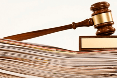 A gavel on top of a stack of papers.
