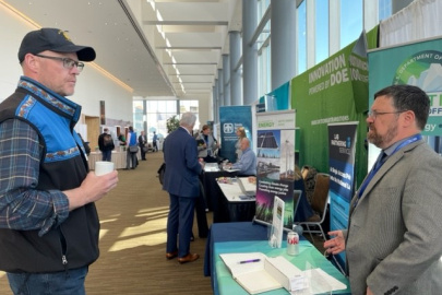 Matt Bergan from Kotzebue Electric, left, speaks with Arctic Energy Office Senior Advisor Mike McEleney at the AEO booth.  