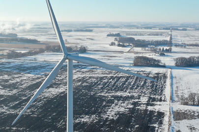 Distributed wind turbine with facility on a snowy day.