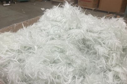 A large amount of recycled glass fiber placed in a cardboard box.
