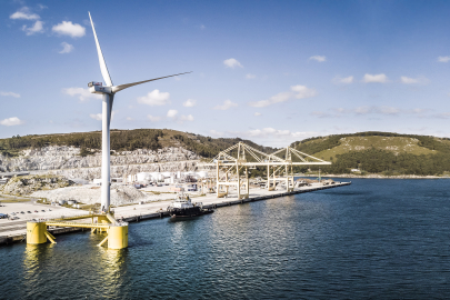 Aerial view of a wind turbine at a dock.