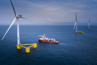 Offshore wind turbines and a boat at sea.