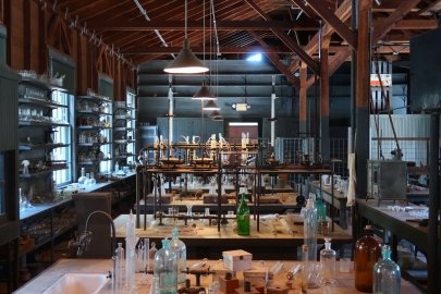 a photo of a lab, with tables covered in glass vials. 