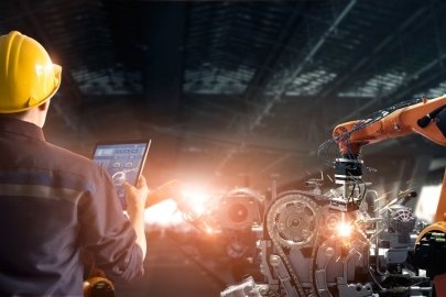 a picture of a person looking at a robotic arm