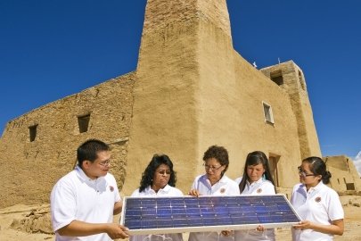 local residents holding solar panels