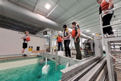 MECC participants stand around a wave tank.